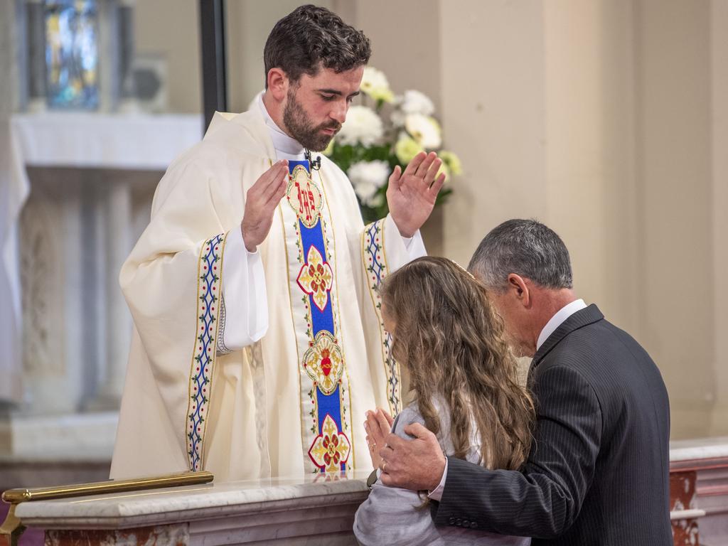 Father Nathan Webb blesses his parents Fiona and Paul Webb. Ordination of Nathan Webb at St Pat's Cathedral. Saturday, June 25, 2022. Picture: Nev Madsen.