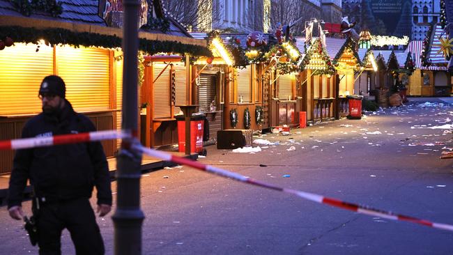 A policeman walks through the shuttered Christmas market the day after a terror attack in Magdeburg, Germany. Picture: Omer Messinger/Getty Images