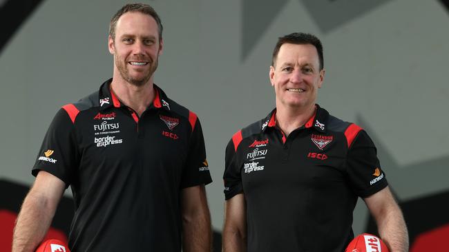 John Worsfold will hand the coaching reins at Essendon to Ben Rutten at the end of 2020.