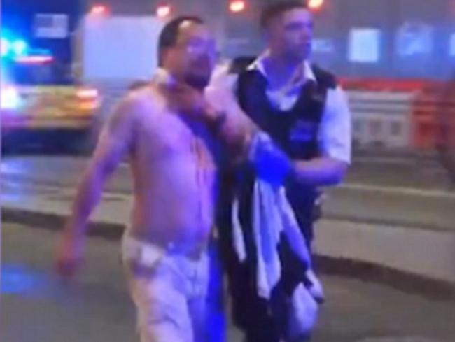 Journalist Geoff Ho pictured trying to stop the bleeding from a neck wound as he staggered down the street outside the Southwark Tavern. Picture: Supplied