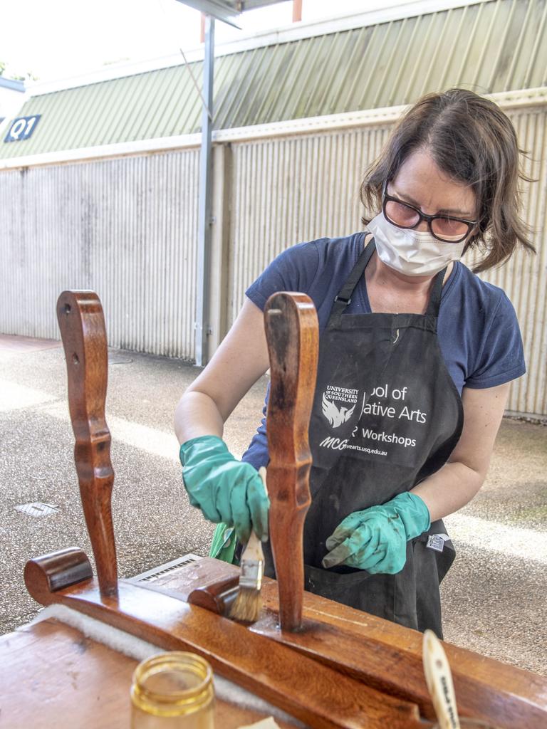 Carey Schotten applying shellac. Furniture upholstery and restoration class with Deka Design. McGregor Summer School at USQ. Friday, January 14, 2022. Picture: Nev Madsen.