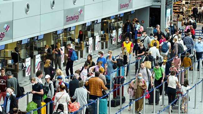 Passengers queue at the check-in counter of airline Eurowings, a subsidiary of the Lufthansa Group, at Dusseldorf International Airport this month. Picture: AFP