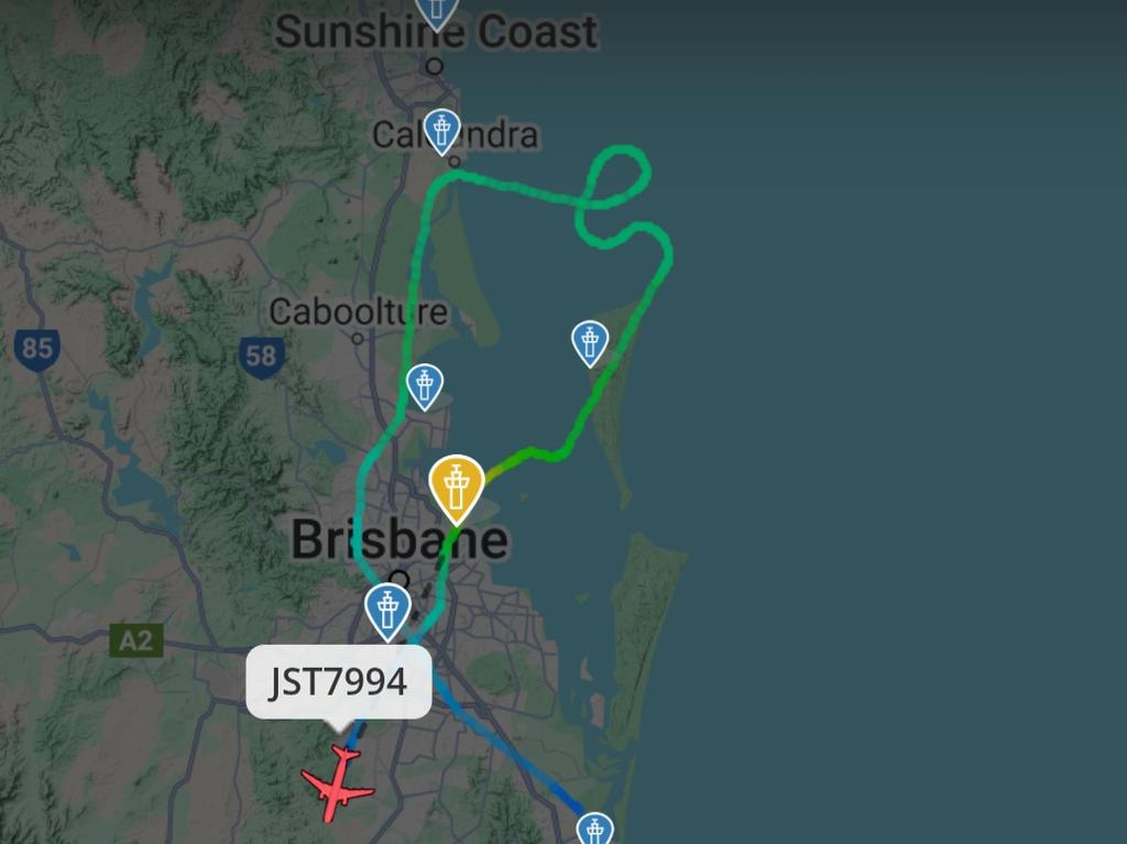 Planes attempting to land at Brisbane Airport on Saturday night appear to be struggling to navigate the strong gusts.