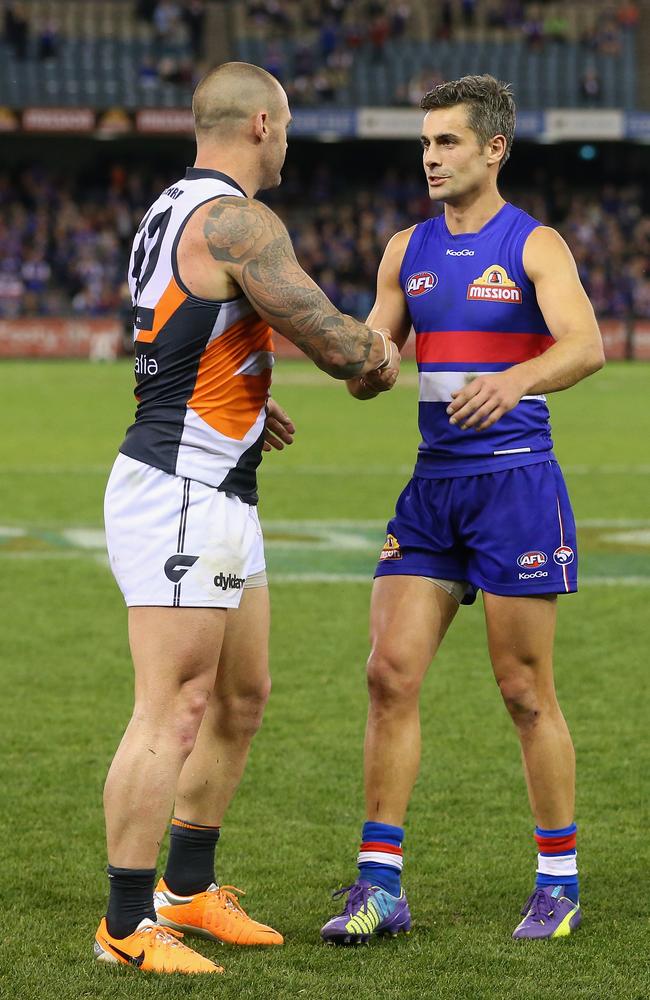 Retiring veterans Josh Hunt and Daniel Giansiracusa congratulate each other after the Giants’ thrilling win over the Bulldogs.