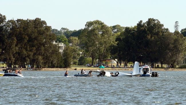 Rescue crews and onlookers rush to the scene. Picture: Daniel Wilkins