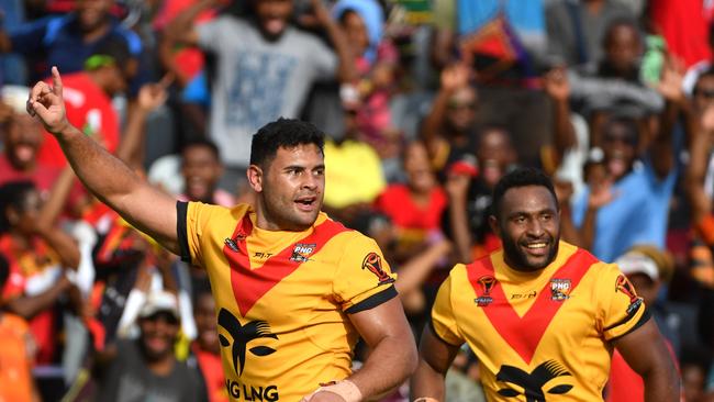 Papua New Guinea's Rhys Martin (left) celebrates after scoring a try during the Rugby League World Cup with Wales Dragons at the National Football Stadium in Port Moresby, Papua New Guinea, Saturday, October 28, 2017. (AAP Image/Mick Tsikas) NO ARCHIVING, EDITORIAL USE ONLY