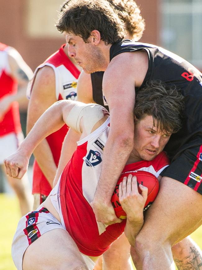 Ben Maguinness of Red Hill is tackled by a Frankston Bombers opponent. Picture Stuart Walmsley