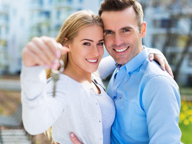 First home buyers purchasing a new property. Holding keys at the front of the property. Picture: iStock.