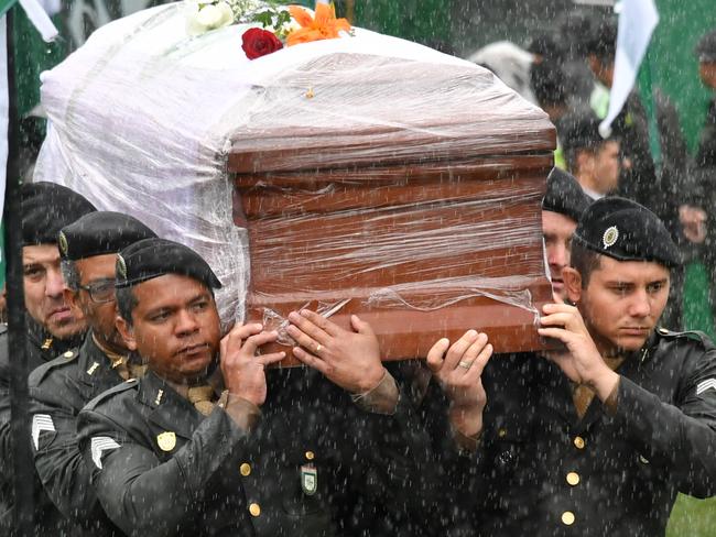 Soldiers carry the coffins of one of the members of Chapecoense Real into the stadium where a massive funeral will be held. Picture: AFP/Nelson Almeida