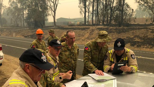 The Melbourne Fire Brigade and Australian Defence Force personnel work together to coordinate Damage Assessments in Sarsfield, East Gippsland.     *** Local Caption *** More than 110 Army Reservists are working with local authorities to provide assistance to community recovery efforts on Kangaroo Island.  The Australian Defence Force (ADF) has commenced Operation Bushfire Assist 19-20 and has stood up a Joint Task Force in New South Wales and Victoria to enhance Defence support following devastating bushfires in the South East of Australia.  ADF members are working side by side with emergency services personnel in the State Disaster Coordination Centre (SDCC) of the New South Wales Rural Fire Service Headquarters and alongside the Victorian CFA is the Country Fire Authority and Metropolitan Fire Brigades to provide best effect of ADF assets.  HMAS Choules and MV Sycamore have sailed from Sydney and will operate off the Southern NSW/North East Victorian coast to provide support to communities cut off due to the bushfires.  Defence is also providing transport and other capabilities such as aviation ground support, logistics, engineering and accommodation support the firefighting effort.