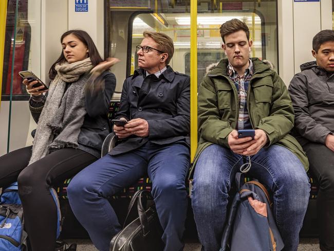 London, England - March 20, 2018: Four passengers in the famous London underground train