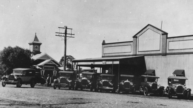 Cars for hire at Kingaroy, 1926. Townson and Heaslop Cars and Garage, situated at the corner of Kingaroy and Alford Streets, reflect the town’s embrace of the automotive age. The School of Arts with its bell tower is visible on the left. Source: Unknown