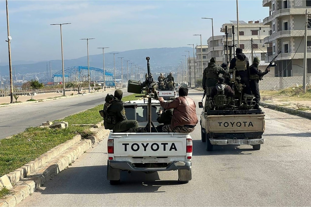 A handout picture from the Syrian state news agency SANA showing members of the security forces in Syria's coastal region