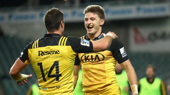 Beauden Barrett of the Hurricanes celebrates scoring a try with teammate Cory Jane.