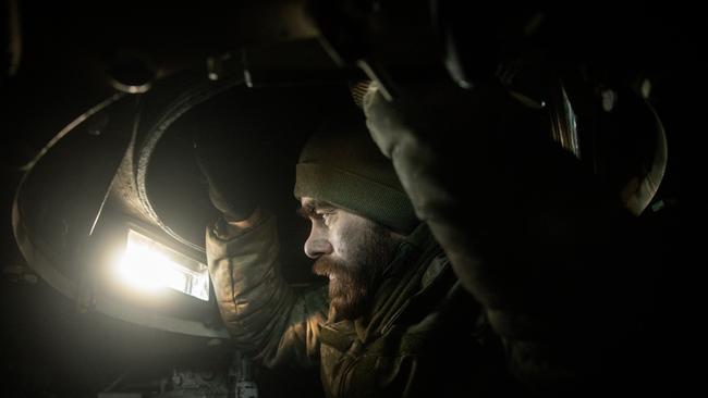 A member of a Ukrainian artillery unit watches out from a small hatch window inside a M109 self propelled artillery unit as they come under Russian shelling in Donetsk Region. Ukraine’s battle against the Russian invasion is consuming ammunition at rates unseen since World War II. Picture: Getty