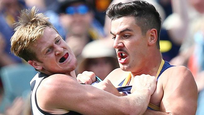 Port Adelaide’s Tom Jonas battles against Adelaide’s Taylor Walker.