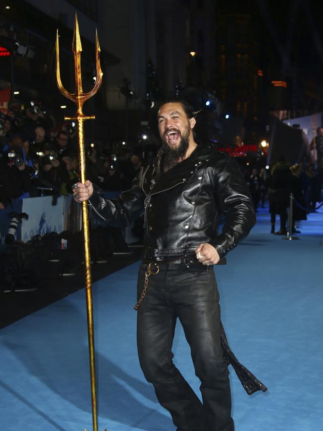 Jason Momoa poses for photographers upon arrival at the premiere of the film Aquaman in central London.