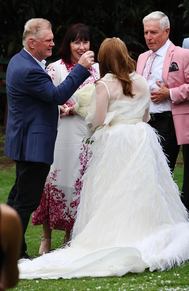 The 50-something-year-old bride wore a cream feathered chiffon gown and carried cream chrysanthemums. Picture: WP Media
