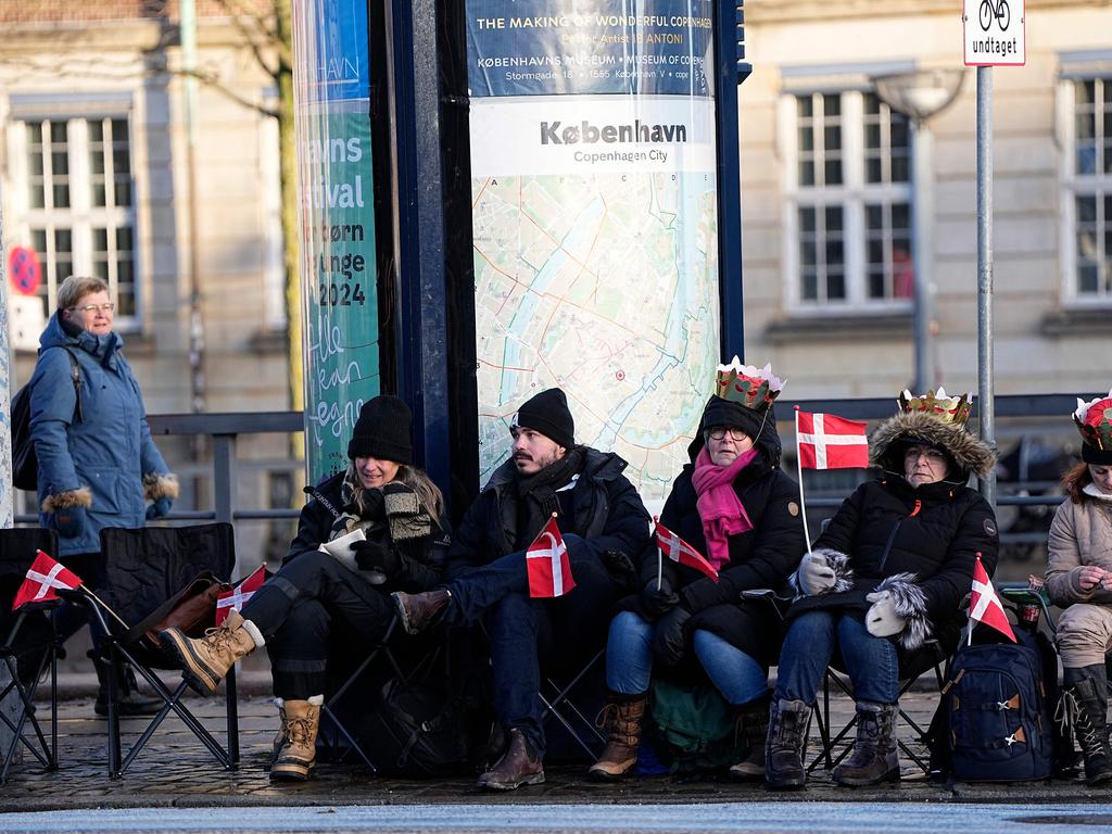Members of the public sit in camping chairs on Christiansborg Palace Square ahead of the proclamation. Picture: Mads Claus Rasmussen / Ritzau Scanpix / AFP