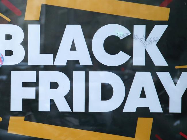 (FILES) In this file photo taken on November 29, 2019 People walk past a "Black Friday" logo on a banner in Ajaccio, on the French Mediterranean island of Corsica, on November 29, 2019 . - The French Economy and Finance minister on November 18, 2020 asked retailers to postpone the "Black Friday" promotional operation scheduled for November 27, while the government is to decide in the upcoming days when so-called "non-essential" businesses, closed over Covid-19 lockdown restrictions, will be able to reopen. (Photo by PASCAL POCHARD-CASABIANCA / AFP)