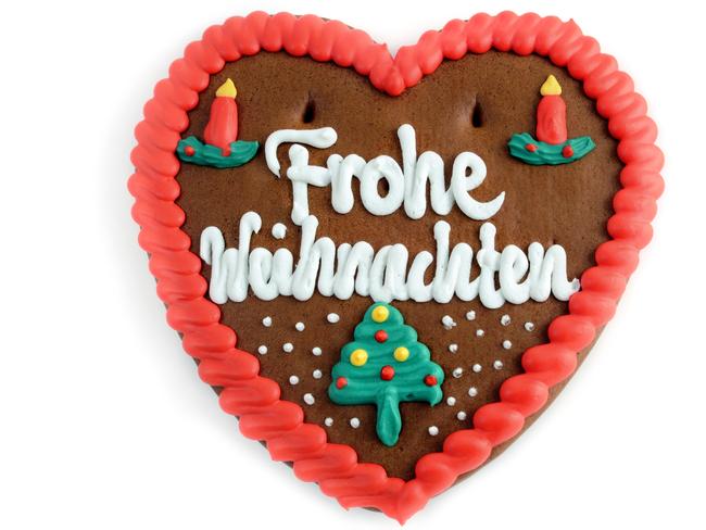 Merry Christmas written in German on a gingerbread heart, or lebkuchen.