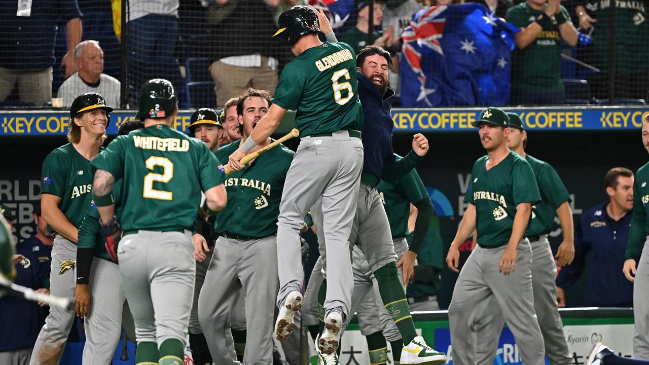 Robbie Glendinning #6 and Aaron Whitefield #2 of Australia celebrate with teammates after scoring runs in the World Baseball Classic Pool B game between Australia and Czech Republi.