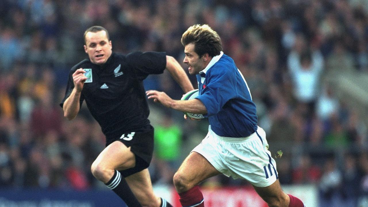 Christophe Dominici takes on Christian Cullen during France's 43-31 win against New Zealand at the 1999 World Cup. Picture: Alex Livesey /Allsport