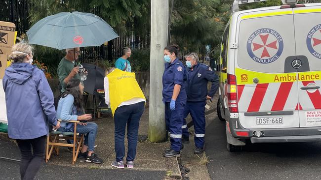 The injured woman rests in a chair as ambulance paramedics arrive at the polling booth at Nambucca Heads Public School. Picture: Chris Knight