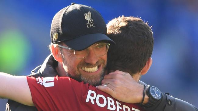 CARDIFF, WALES - APRIL 21:  Jurgen Klopp, Manager of Liverpool celebrates victory with Andy Robertson after the Premier League match between Cardiff City and Liverpool FC at Cardiff City Stadium on April 21, 2019 in Cardiff, United Kingdom. (Photo by Mike Hewitt/Getty Images)