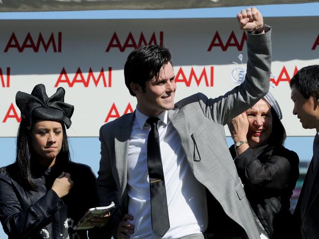 Victory salute: trainer James Cummings (centre) celebrates with his wife Monica (left) after his horse Prized Icon won the Victoria Derby. Picture: AAP