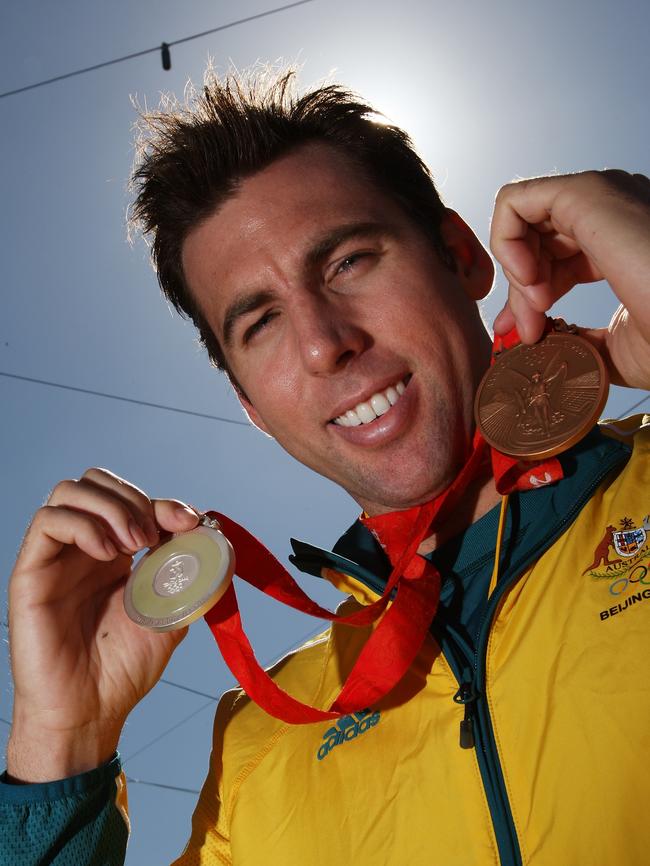 Swimmer Grant Hackett poses with his medals during a welcome home parade for the Beijing 2008 Olympic athletes. Picture: Kristian Dowling/Getty Images