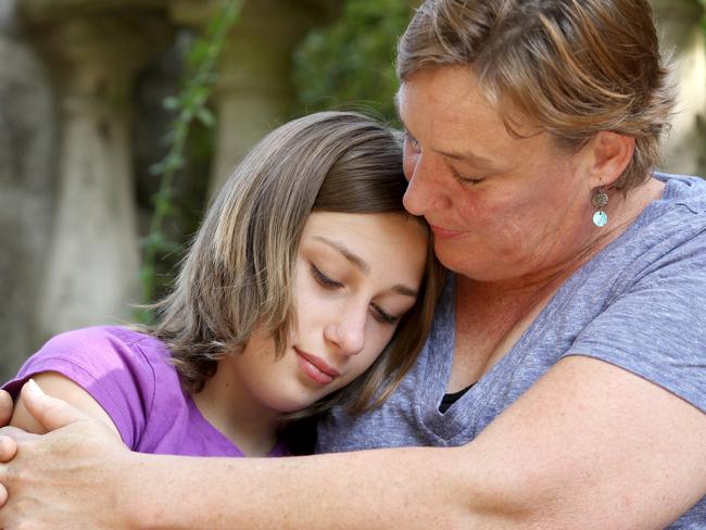 Mother consoling her teenage daughter.