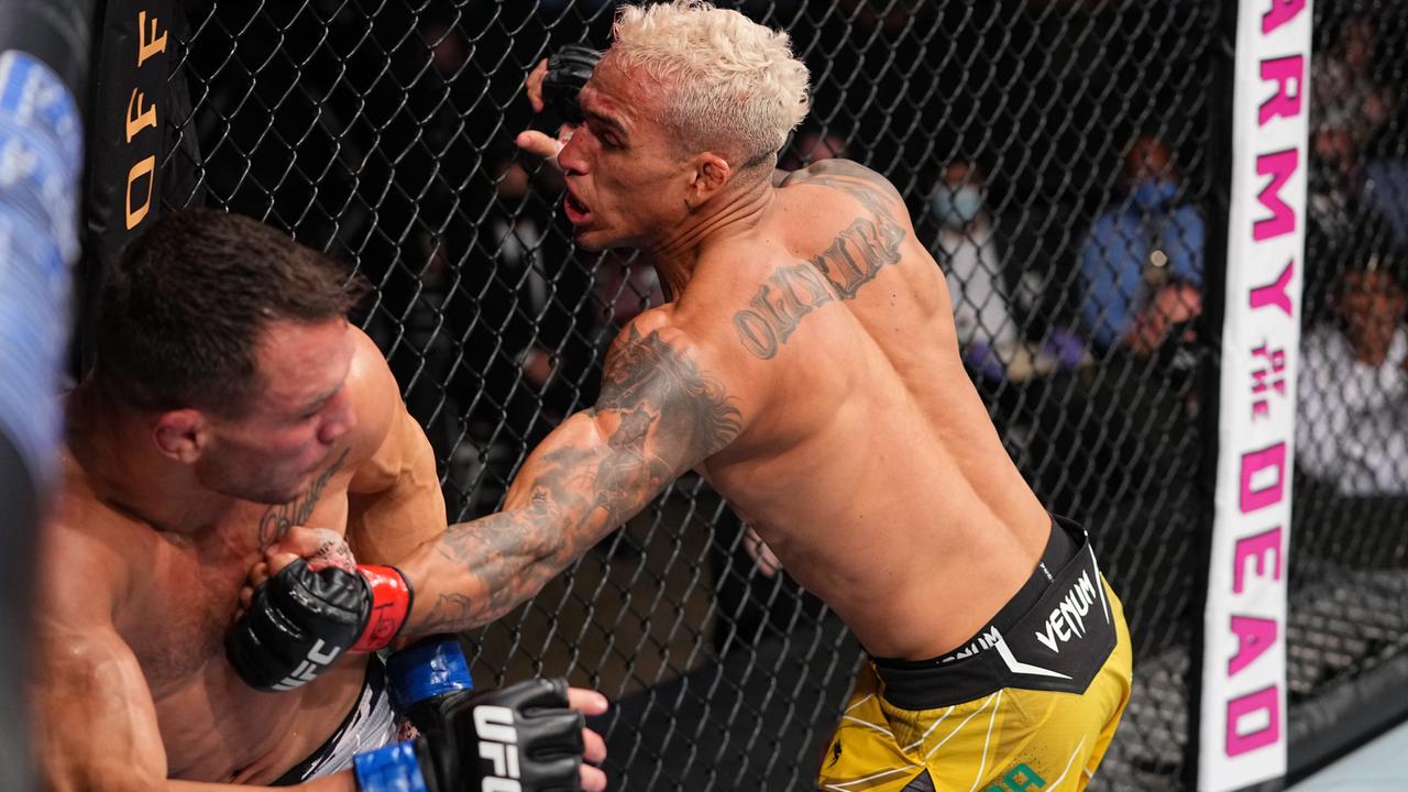 Charles Oliveira of Brazil punches Michael Chandler.