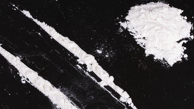 cocaine powder in lines on a black background