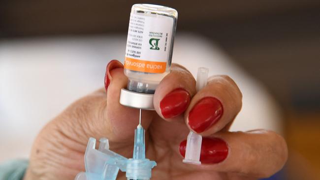 A healthcare worker prepares to give someone a Covid-19 vaccine. Picture: AFP