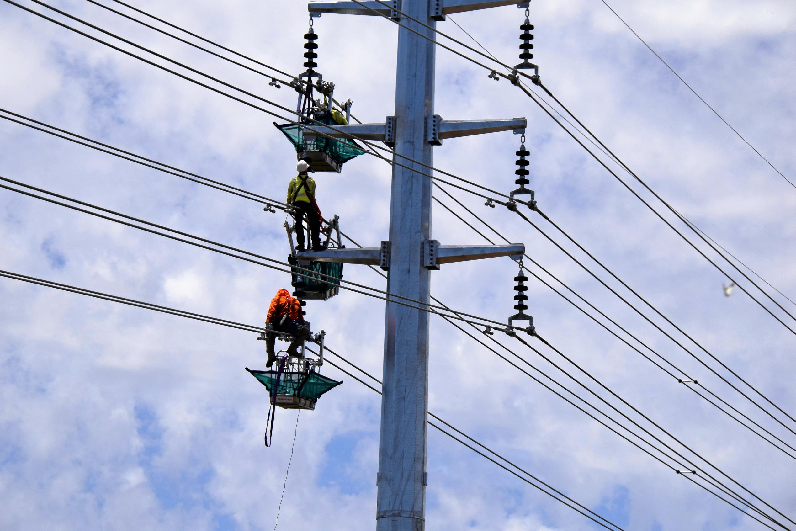 HANGING OUT: Coopers Gap workers fit cables to towers. Picture: Matt Collins