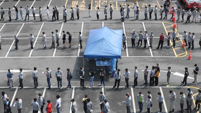 Hyundai Heavy Industries employees wait in lines to take tests for the COVID-19 coronavirus at a virus testing station in the southeastern port city of Ulsan on September 9, 2020, after seven people including company employees and their family members were confirmed as new coronavirus cases. - South Korea largely overcame an early coronavirus outbreak with extensive tracing and testing, but is now battling several outbreaks mostly linked to Protestant churches. (Photo by - / YONHAP / AFP) / - South Korea OUT / REPUBLIC OF KOREA OUT NO ARCHIVES RESTRICTED TO SUBSCRIPTION USE