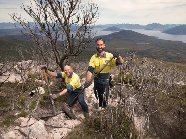 Track builders Dan Rowe, left, and Cam Sweeney work to restore the Mount Anne Circuit overlooking Lake Pedder in Tasmania’s southwesy. Picture: Peter Mathew