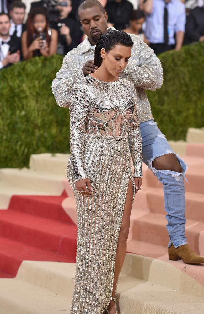 Total control ... Kanye West adjusts his wife, Kim Kardashian’s hair on the red carpet at the Met Gala in New York earlier this week. Picture: Dimitrios Kambouris/Getty Images