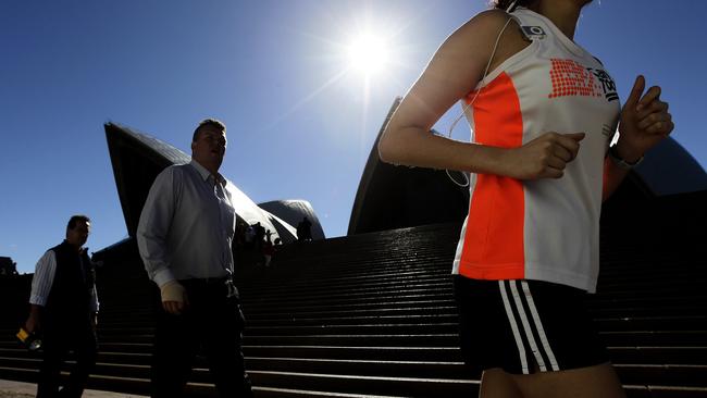 Generic photographs at the foot of the Sydney Opera House steps. Running, jogging, walking, tourist, sunny, sun, blue sky, jogger, shoes, feet