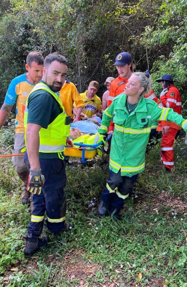 Rescuers carrying William Dilworth out of the rainforest where he was found.