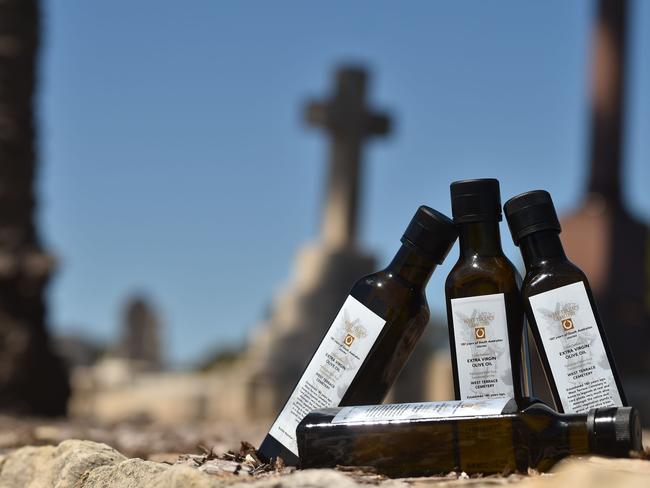 Bottles of 2017 limited edition olive oil, harvested from trees at an Adelaide cemetery to shake-up people's attitudes towards death and burial sites. Picture: AFP/Peter Parks