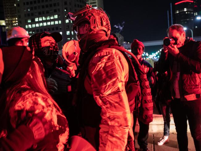 A Trump supporter faces off with the military outside the TCF election centre in Detroit, Michigan. Picture: AFP