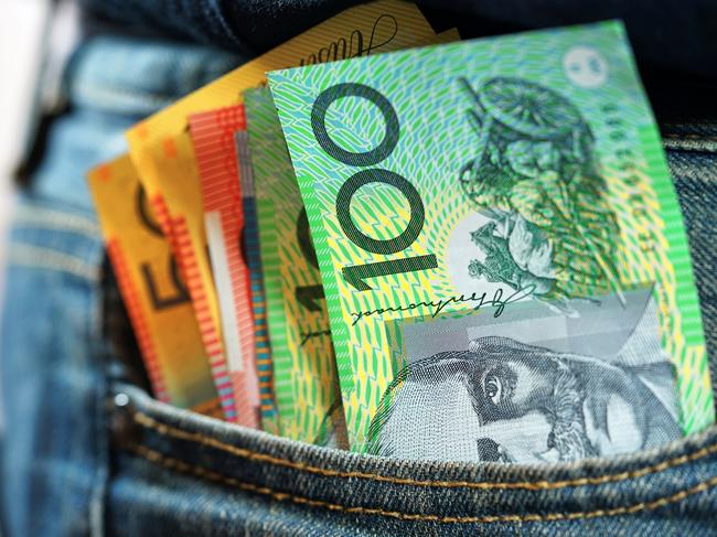 Australian cash money in mans jeans pocket, close up.