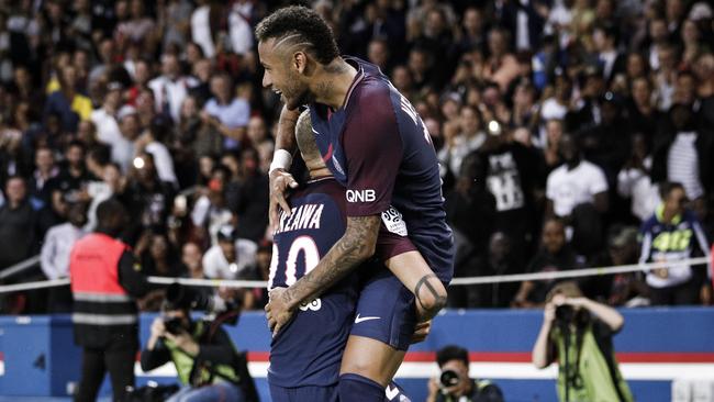 PSG's Neymar jumps over PSG's Layvin Kurzawa.