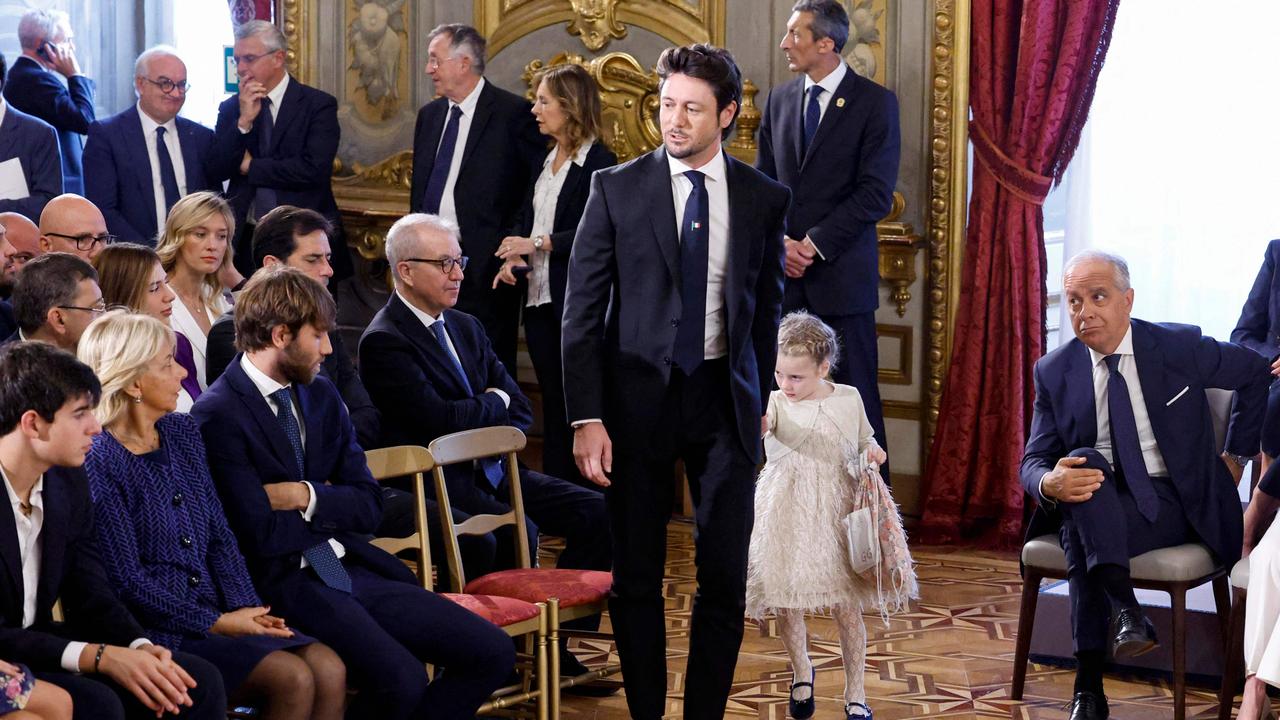Andrea Giambruno, in the centre, the partner of Italy's new Prime Minister Giorgia Meloni, with their daughter attend the swearing-in ceremony of the new Italian Government at the Quirinal Palace in Rome on October 22, 2022. Picture: Fabio Frustaci / ANSA / AFP