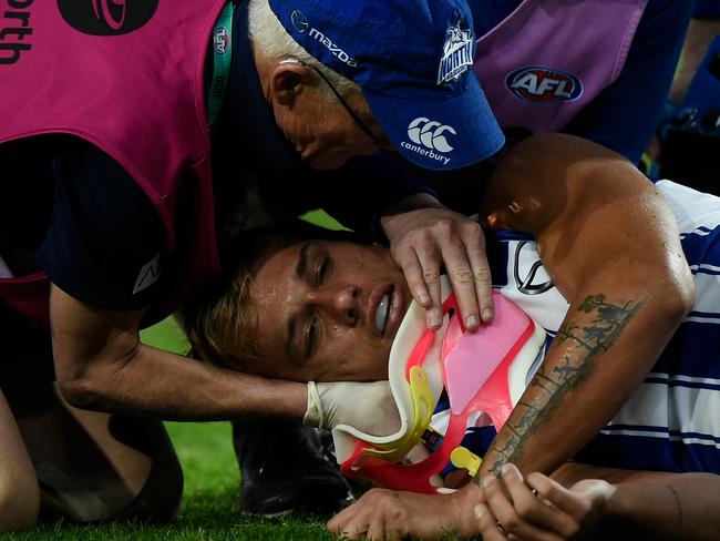 GOLD COAST, AUSTRALIA - JULY 18: Kyron Hayden of the Kangaroos leave the field injured during the round 7 AFL match between the Richmond Tigers and the North Melbourne Kangaroos at Metricon Stadium on July 18, 2020 in Gold Coast, Australia. (Photo by Matt Roberts/AFL Photos/via Getty Images)