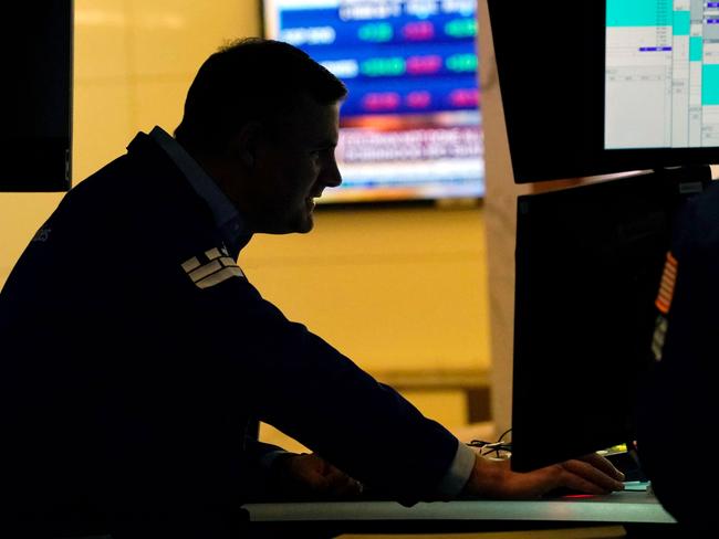 Traders work on the floor at the New York Stock Exchange in New York, on July 29, 2021. - Wall Street stocks climbed early July 29 following another round of mostly strong earnings and US data that showed strong second-quarter growth that lagged expectations. (Photo by TIMOTHY A. CLARY / AFP)