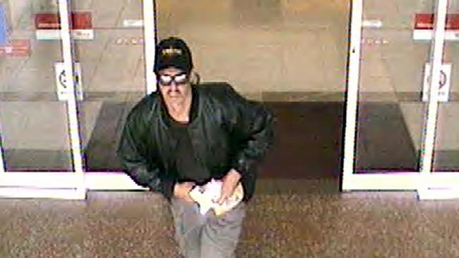 A security video grab of man wanted over the robbery of the Suncorp Metway Bank branch at Chermside shopping centre in April 2004.