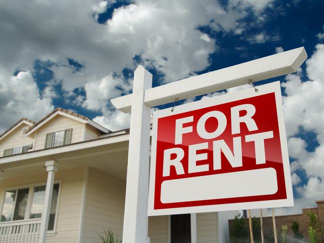 Left Facing Red For Rent Real Estate Sign in Front of Beautiful House.